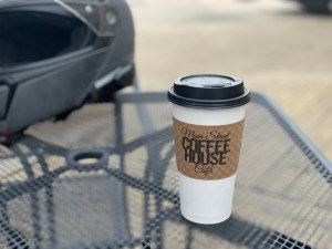 photo of a to go coffee cup sitting on a table
